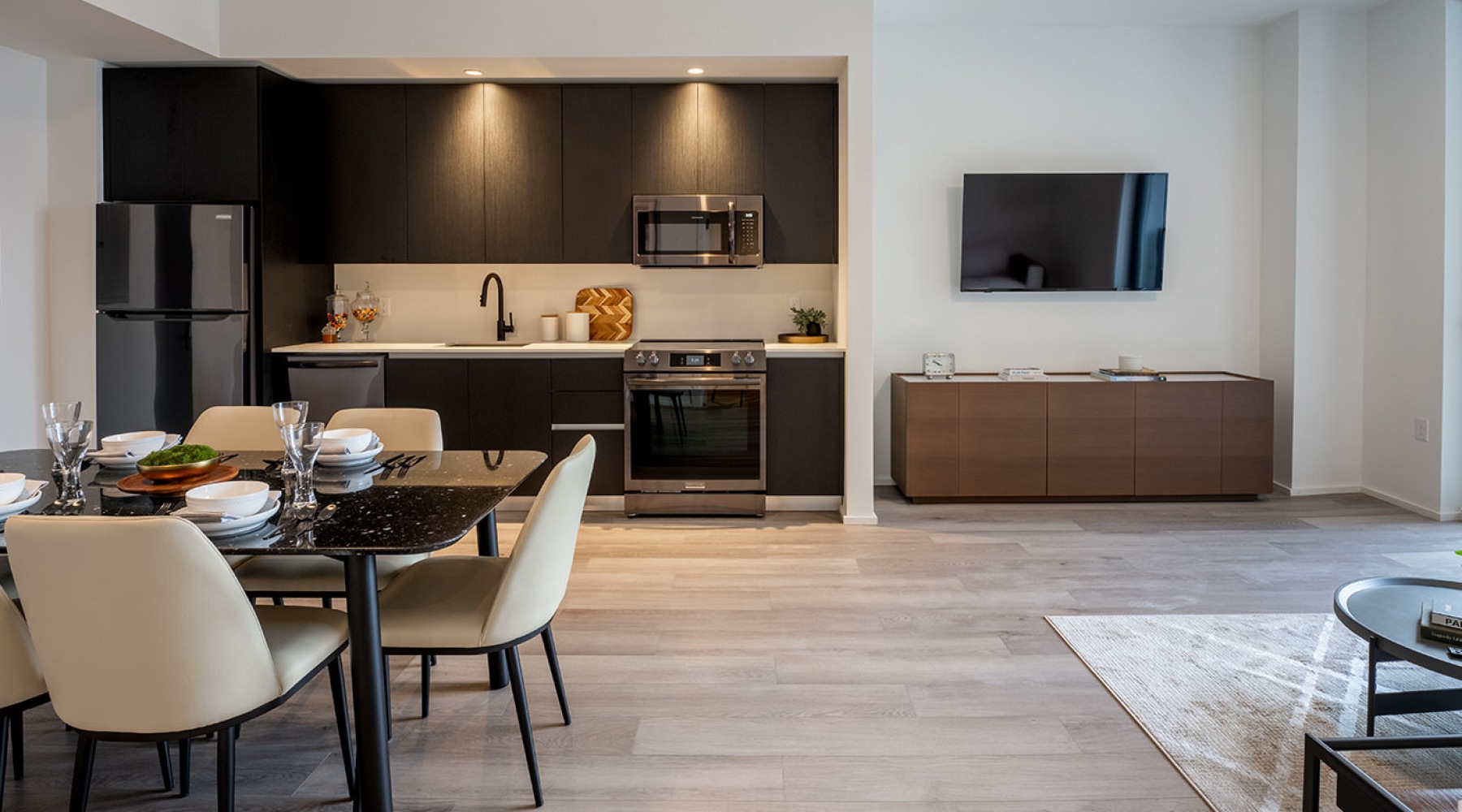 a living room with table chairs and large window