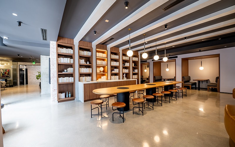 large room with large table chairs and bookshelves